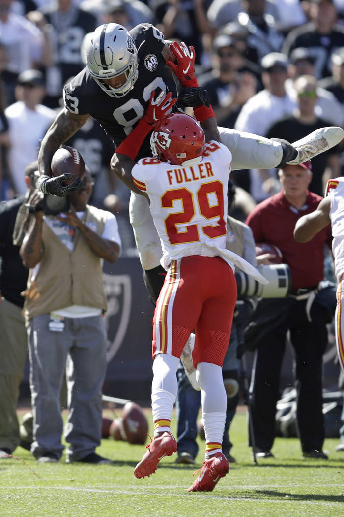 Oakland Raiders tight end Darren Waller carries the ball over Kansas City Chiefs cornerback Ken ...