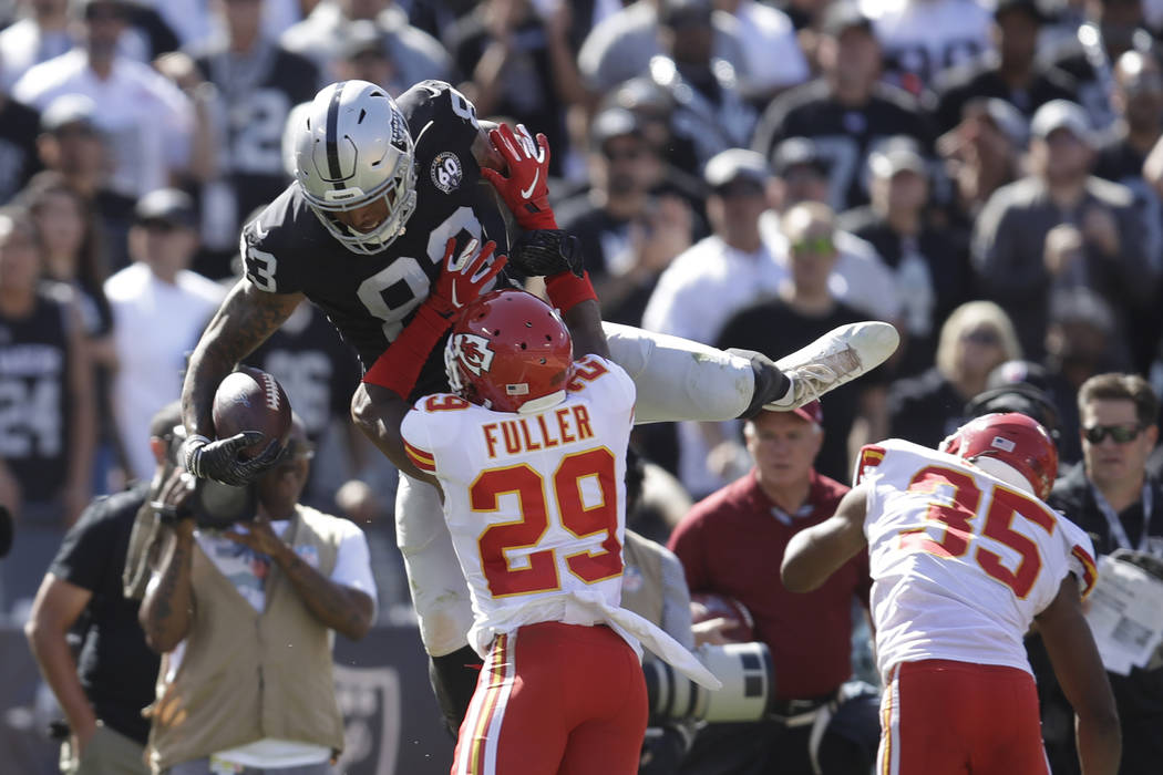 Oakland Raiders tight end Darren Waller, leaps over Kansas City Chiefs cornerback Kendall Fulle ...