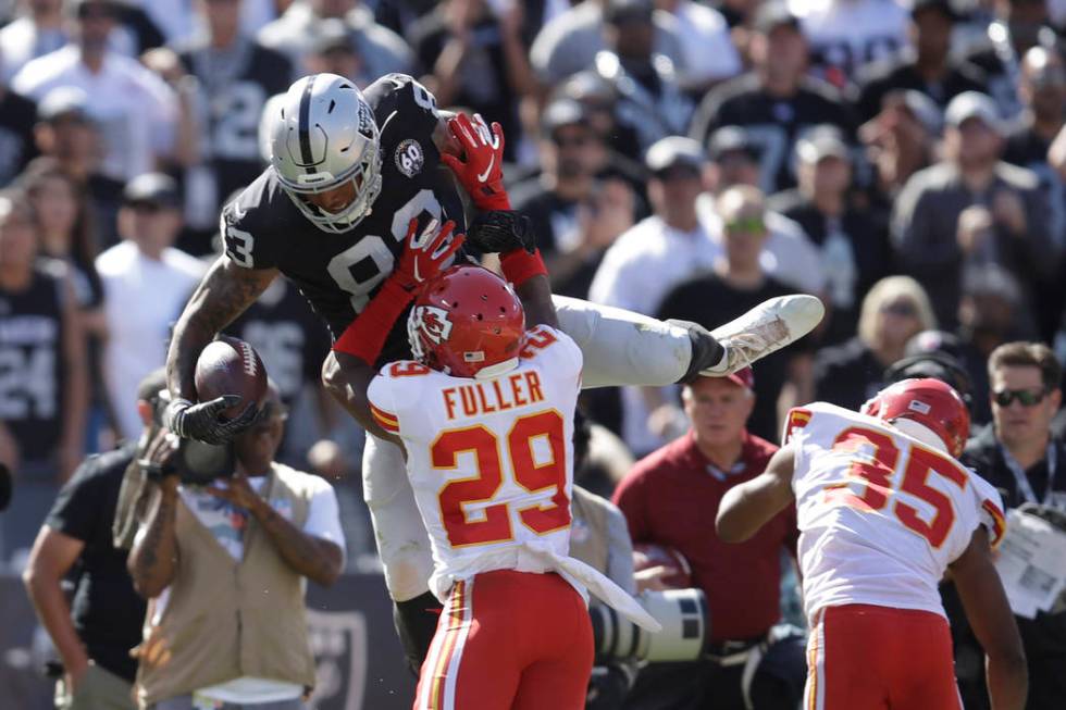 Oakland Raiders tight end Darren Waller, leaps over Kansas City Chiefs cornerback Kendall Fulle ...