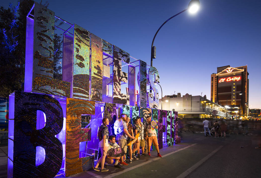Festival-goers pose next to a Life is Beautiful sign on day three of the 2018 festival in downt ...