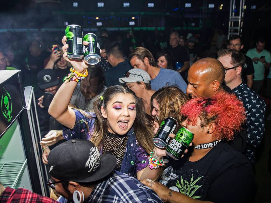 Attendees swarm a free case of special alien edition Bud Light during the Area 51 Celebration o ...