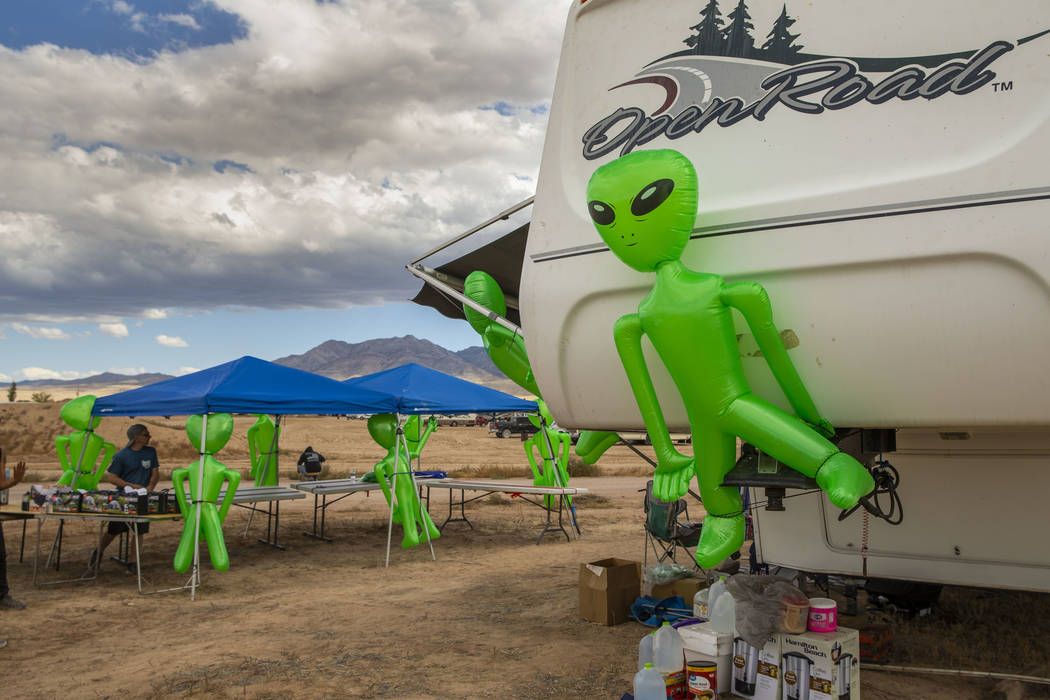 Aliens hang on a merchandise and supply tent as the start of the Alienstock festival nears on T ...