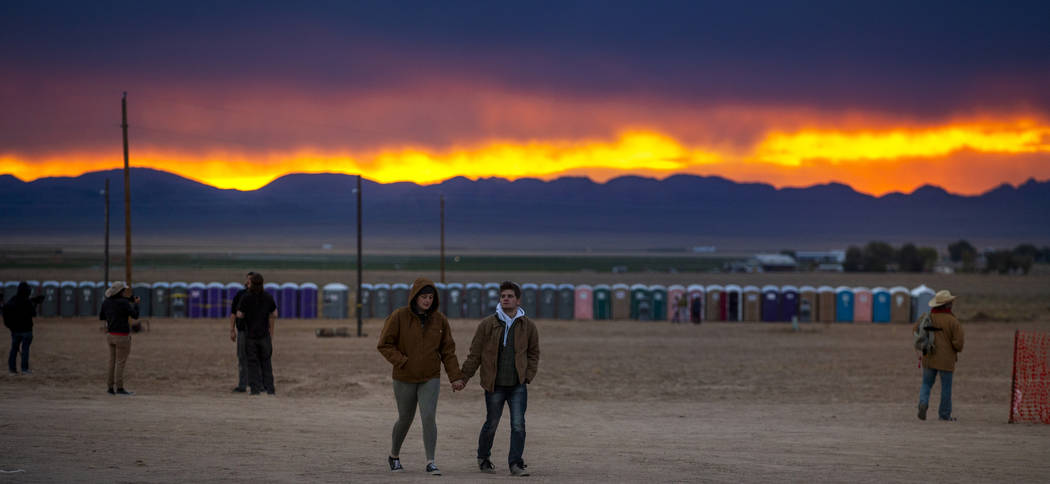 The sun sets on festivalgoers as the start of the Alienstock festival nears on Thursday, Sept. ...