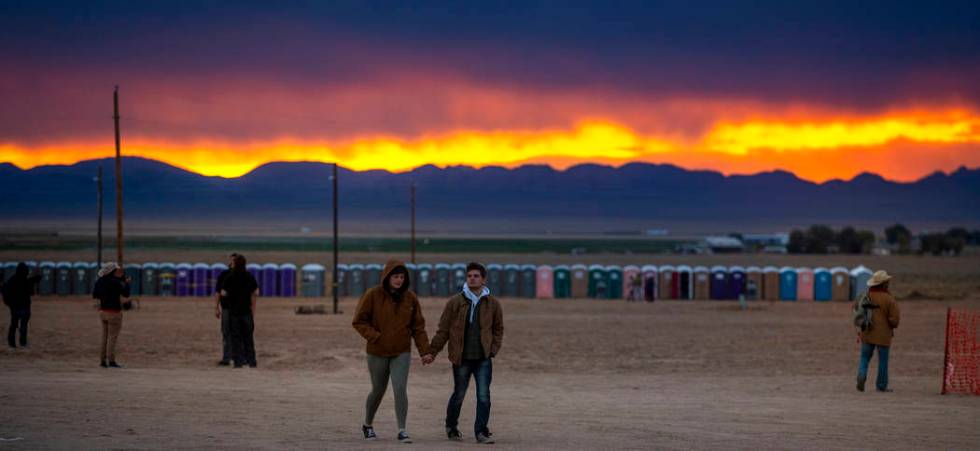 The sun sets on festivalgoers as the start of the Alienstock festival nears on Thursday, Sept. ...