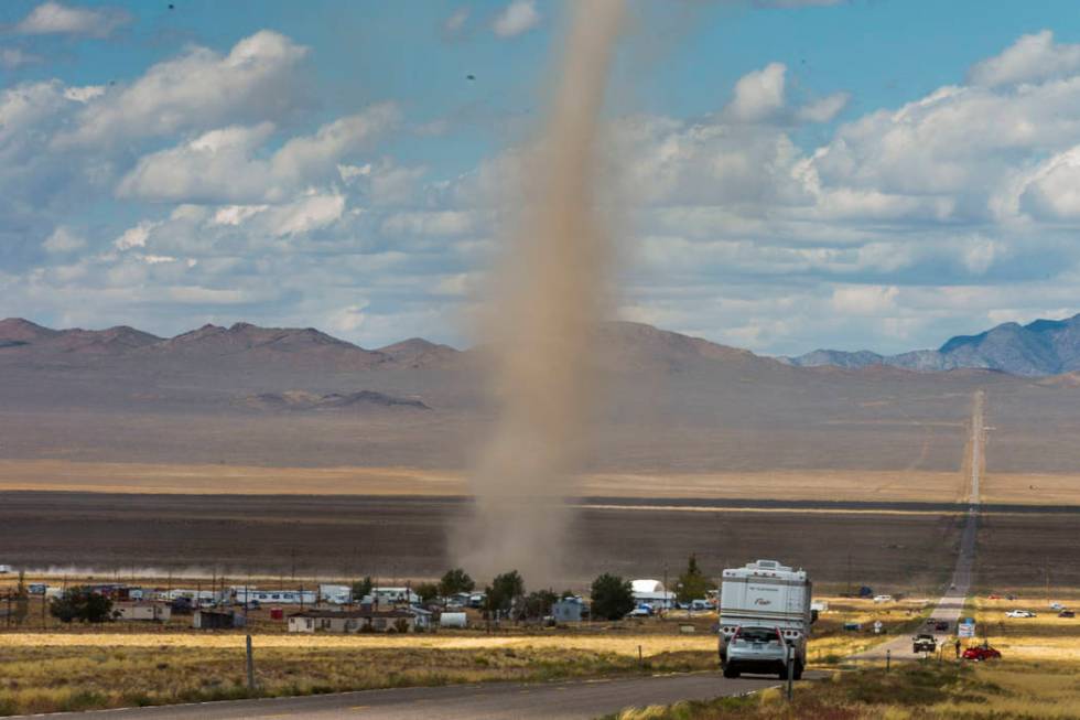 Large dust devil kicks up debris as it passes through Rachel off of state Route 375 as preparat ...