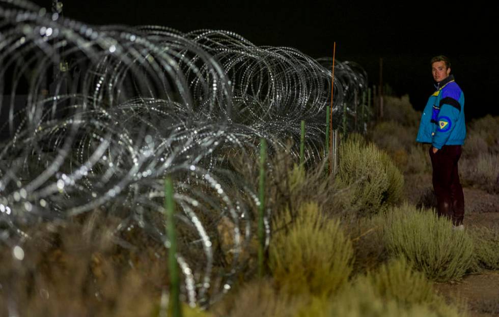 Michael Fortner of Cincinnati wanders along the fence line near the back gate of Area 51 in hom ...