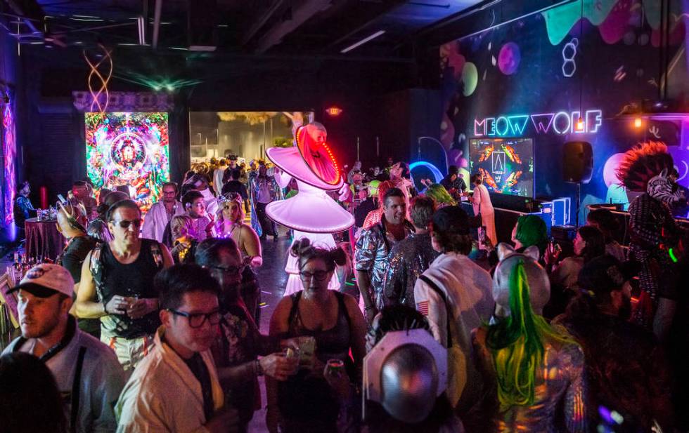 Alien-themed party goers socialize during a pre-party for Storm Area 51 on Thursday, Sept. 19, ...