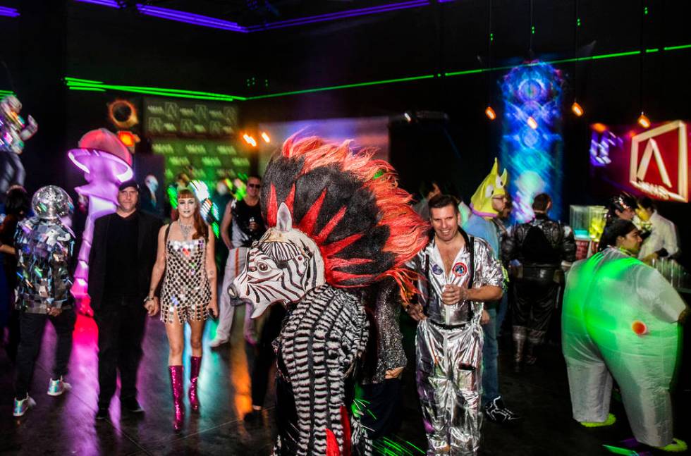 Alien-themed party goers socialize during a pre-party for Storm Area 51 on Thursday, Sept. 19, ...