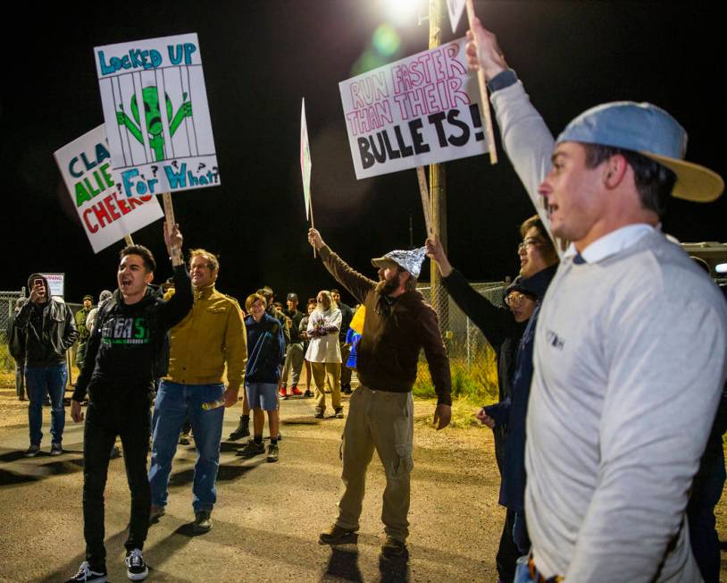 Individuals chant with signs in hand outside the back gate of Area 51 in homage to the original ...