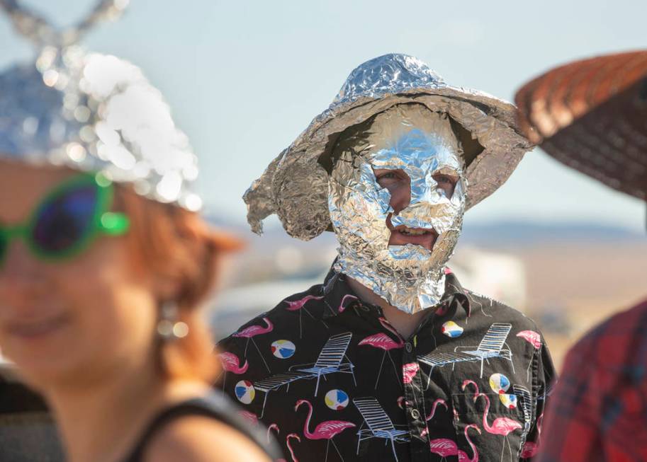 Chris Reid of Reno makes tinfoil hats for festivalgoers during the Alienstock festival on Frida ...