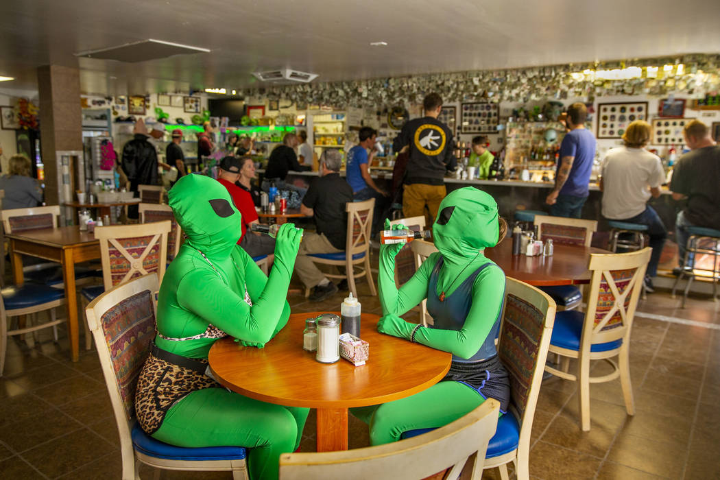 Invader Q-Tip, left, and Invader Stink enjoy a hot sauce breakfast at the Little A'Le'Inn Resta ...