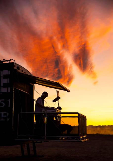 DJ Karn Elofson of Sweden plays into the sunset on his own small stage off of the festival grou ...