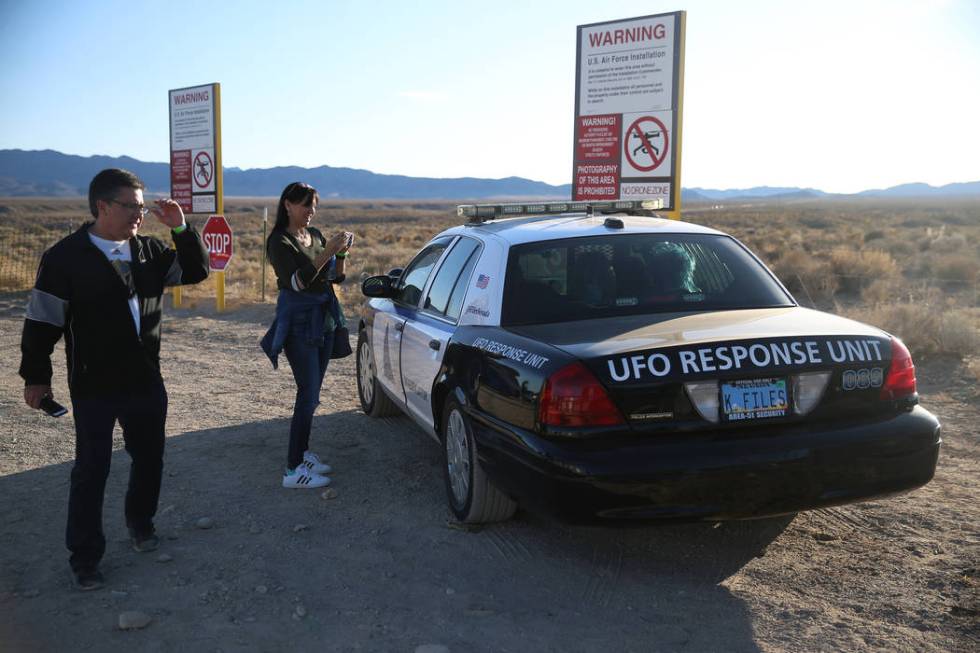 Stan Askew, left, and his date Melissa Pierce, attend the Alien Basecamp alien festival at the ...