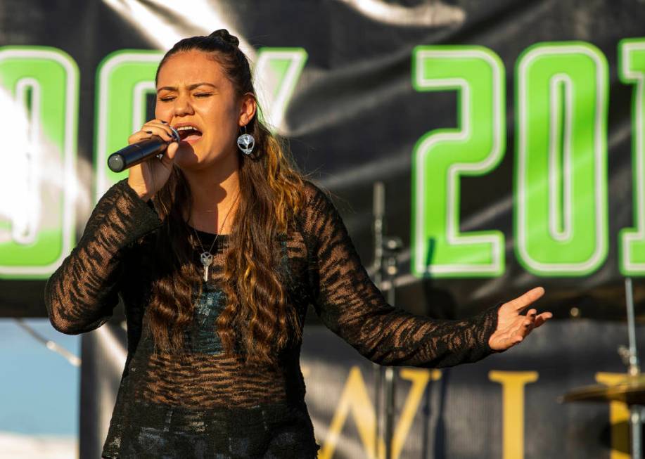 Performer Elyse sings for the crowd on the main stage during the Alienstock festival on Friday, ...