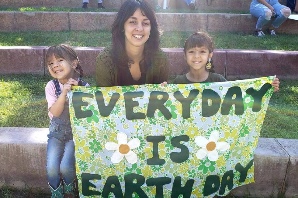 Minimal Market owner Alex Hamilton holds her cloth sign with daughters Amelia, 6, and Ramona, 3 ...