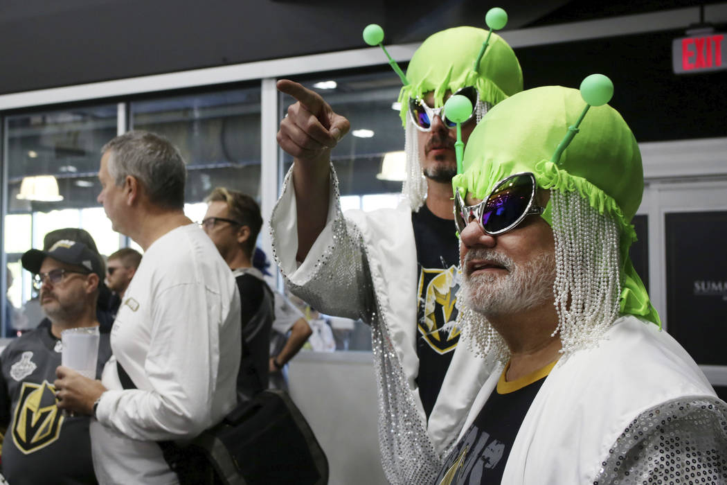 Las Vegas locals Andrew Jason, left, Michael Maybee watch the Golden Knights practice during an ...