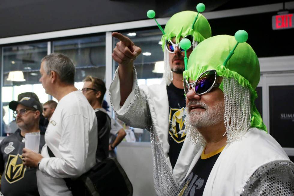 Las Vegas locals Andrew Jason, left, Michael Maybee watch the Golden Knights practice during an ...