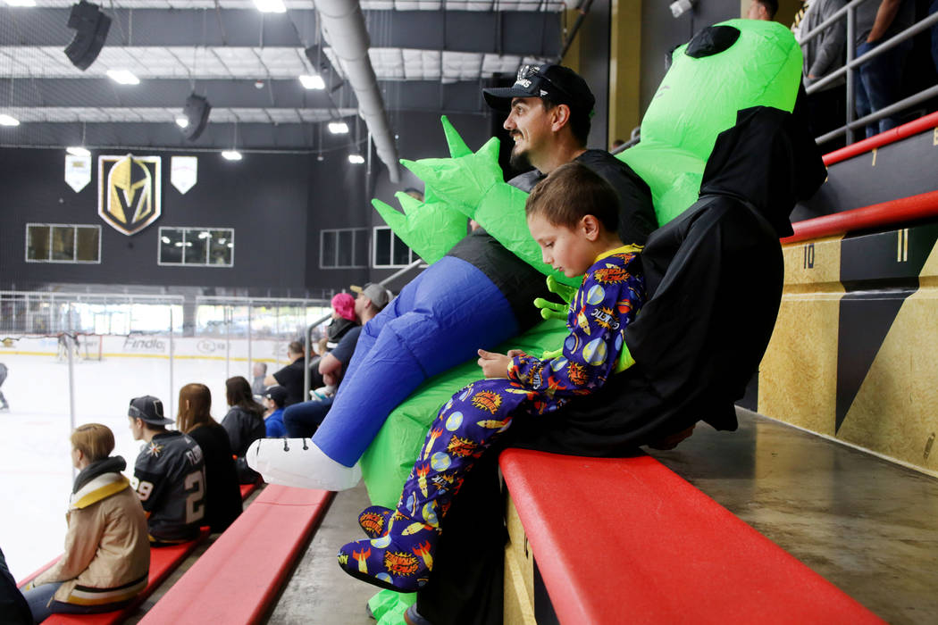 Las Vegas locals Andy Weatherholt, left, and his son Jack Weatherholt, 6, watch the Golden Knig ...