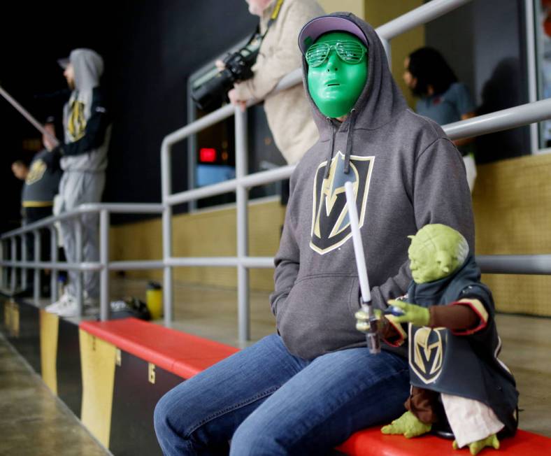 Las Vegas local Randall Keller watches the Golden Knights practice during an alien costume cont ...