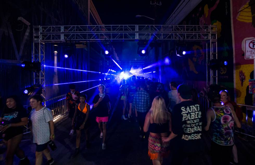 Attendees pass through an illuminated walkway during the first day of the Life is Beautiful fes ...