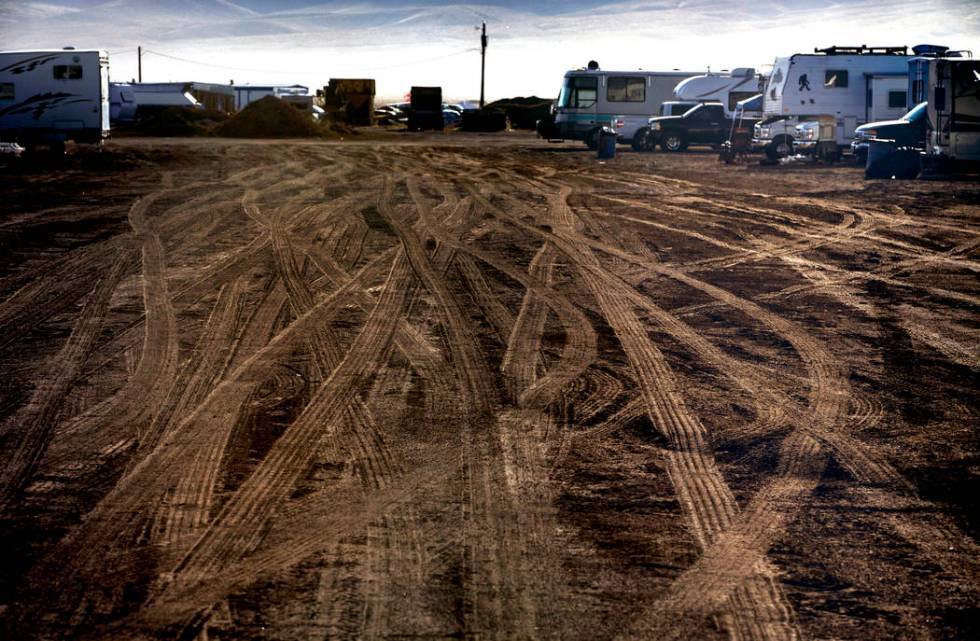 Morning falls on vehicle tracks in the RV parking area during the Alienstock festival on Saturd ...