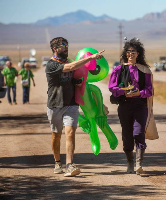 UNICULT members walk up the frontage road carrying aliens and a magic lamp during the Alienstoc ...