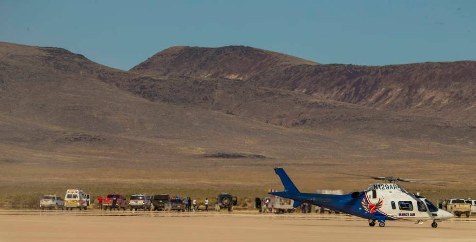 A Mercy Air helicopter prepares to lift off with two injured in a vehicle rollover on the salt ...