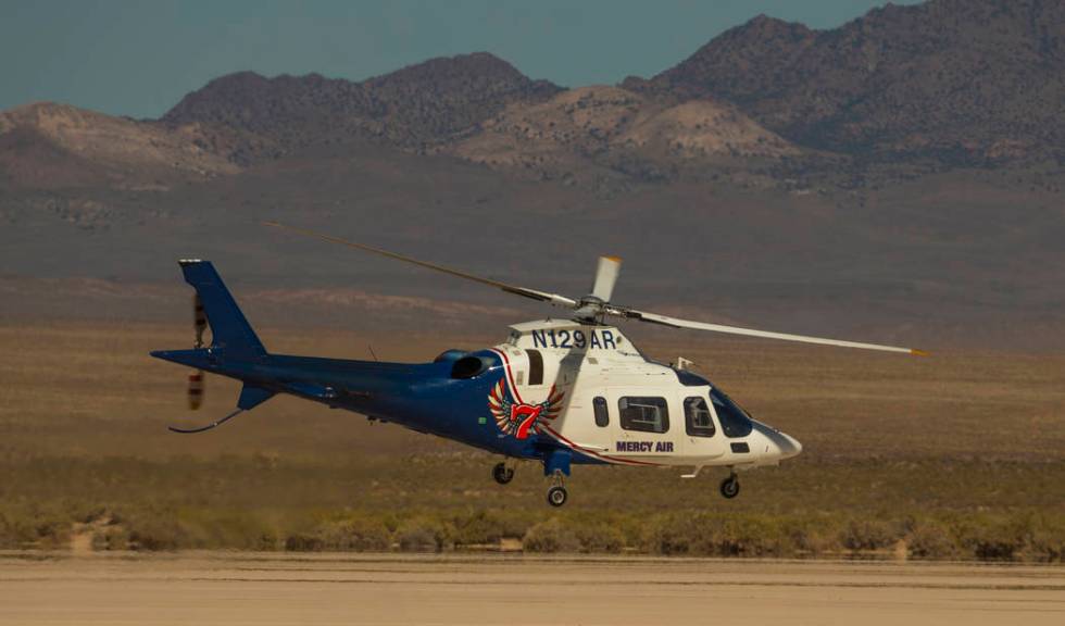 A Mercy Air helicopter lifts off with two injured in a vehicle rollover on the salt flats just ...