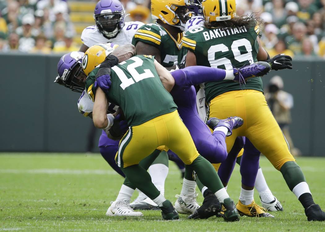 Minnesota Vikings' Danielle Hunter sacks Green Bay Packers' Aaron Rodgers during the second hal ...