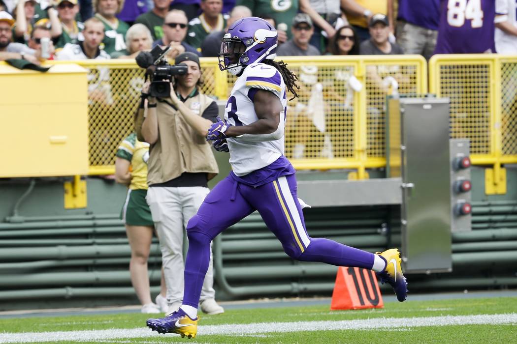 Minnesota Vikings' Dalvin Cook runs for a touchdown during the first half of an NFL football ga ...
