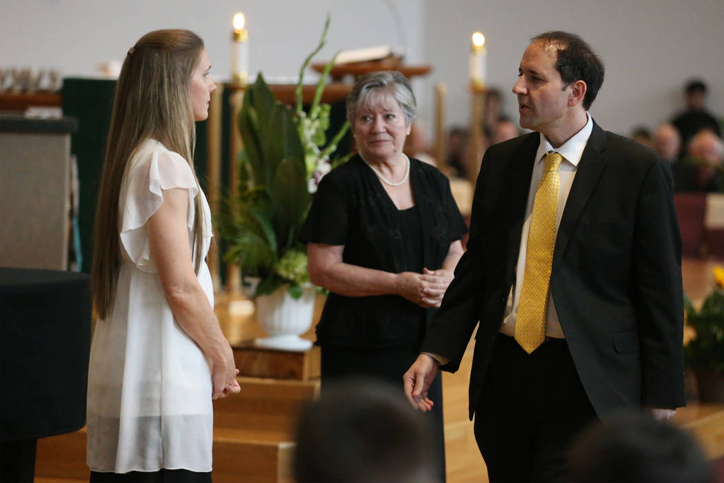 Kara Davis, left, and her husband Sean, are seen during the funeral mass for their daughter Pau ...