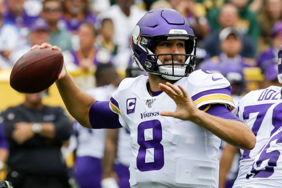 Minnesota Vikings' Kirk Cousins throws during the first half of an NFL football game against th ...