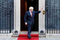 Britain's Prime Minister Boris Johnson waves to welcome the Emir of Qatar, Sheikh Tamim bin Ham ...