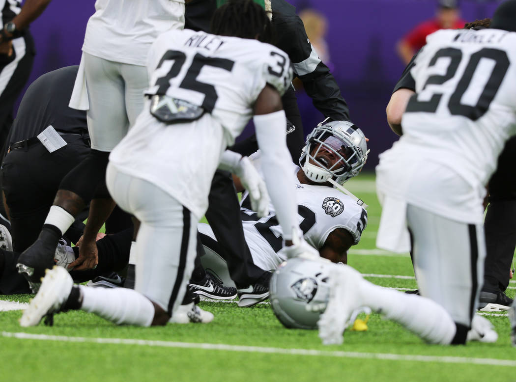 Oakland Raiders middle linebacker Marquel Lee (52) is tended to by trainers after being injured ...