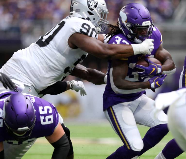 Oakland Raiders defensive tackle Johnathan Hankins (90) tackles Minnesota Vikings running back ...