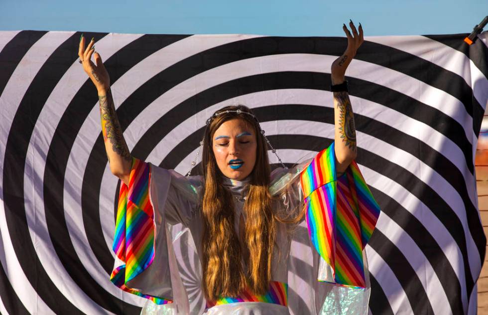 UNICULT leader Unicole, center, leads a morning prayer service for her members and festivalgoer ...