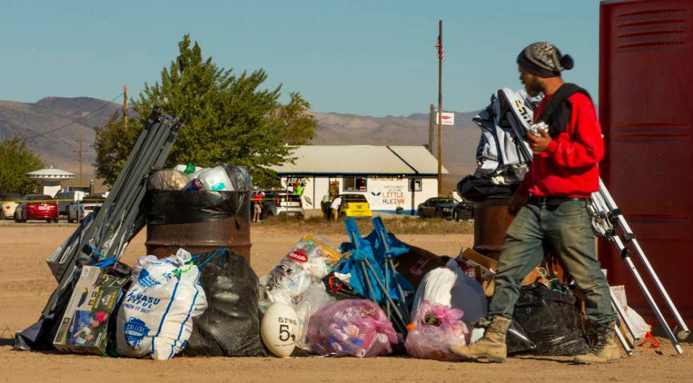 Trash is orderly stacked in the parking area across from the Little A'Le'Inn as festivalgoers d ...