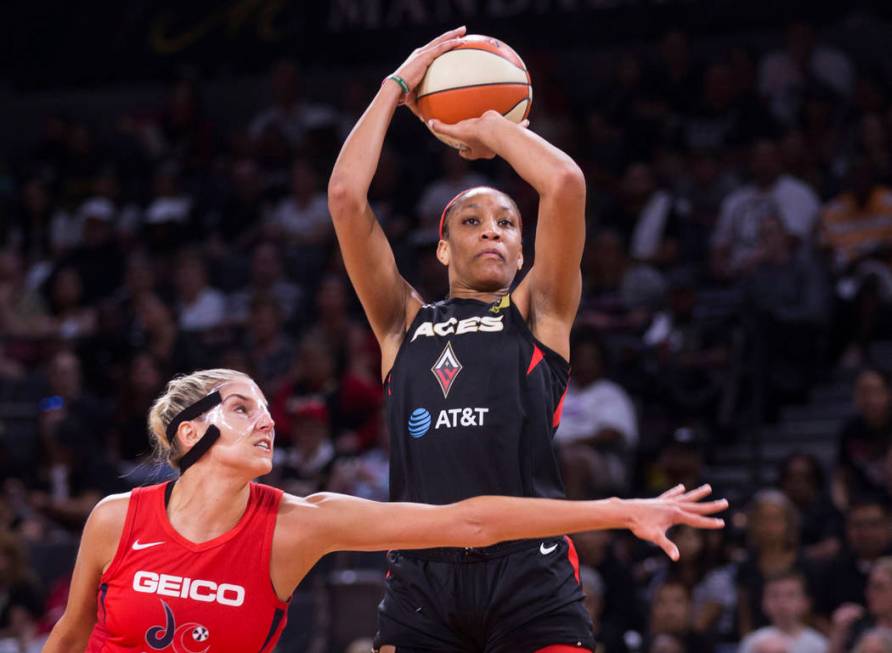 Las Vegas Aces center A'ja Wilson (22) shoots over Washington Mystics forward Elena Delle Donne ...