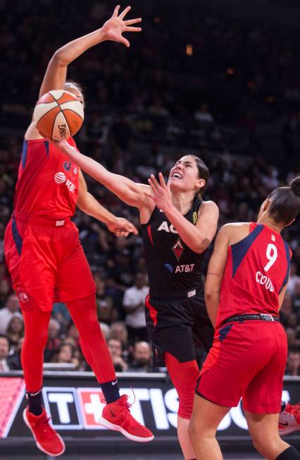 Las Vegas Aces guard Kelsey Plum (10) slices to the rim past Washington Mystics guard Natasha C ...