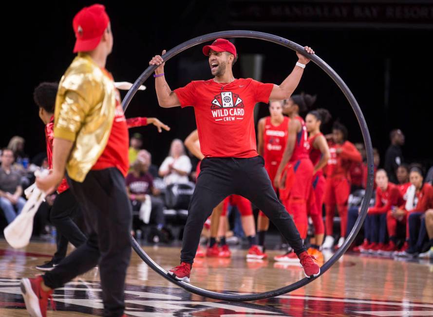 Las Vegas Aces Wild Card Crew member Adam Moss, middle, entertains the crowd in the second quar ...