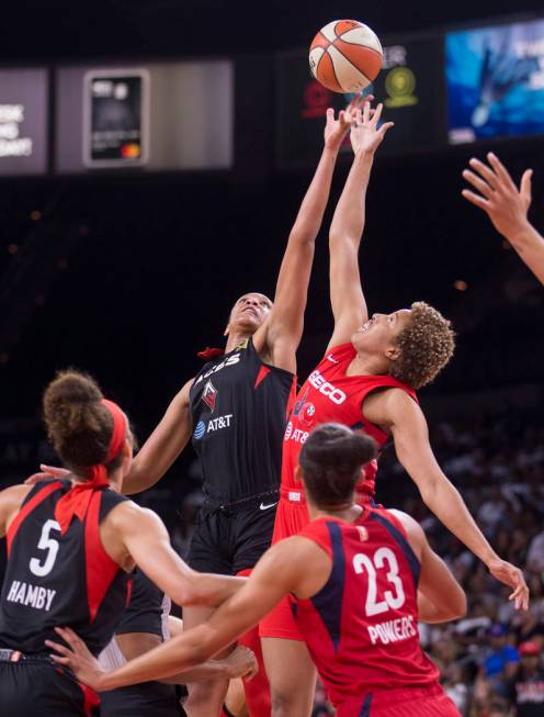 Las Vegas Aces center A'ja Wilson (22) leaps for a jump ball with Washington Mystics forward Ti ...