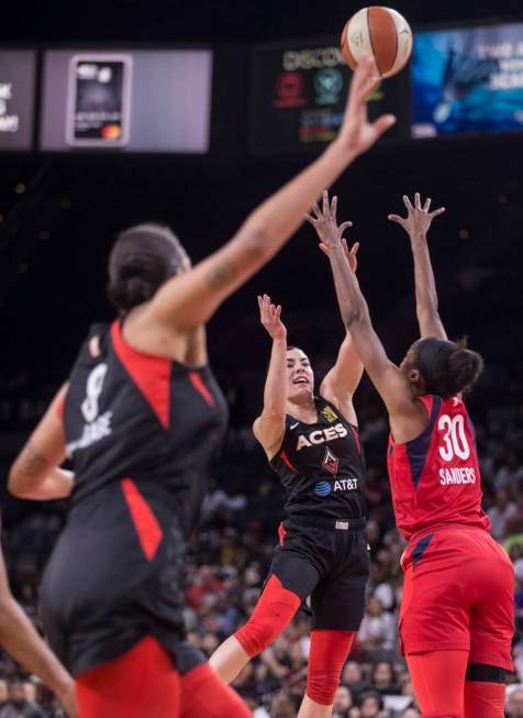 Las Vegas Aces guard Kelsey Plum (10) feeds the ball to Las Vegas Aces center Liz Cambage (8) ...