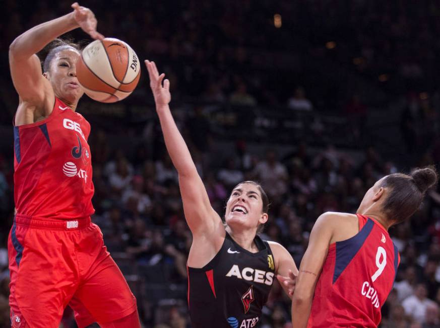 Las Vegas Aces guard Kelsey Plum (10) slices to the rim past Washington Mystics guard Natasha C ...