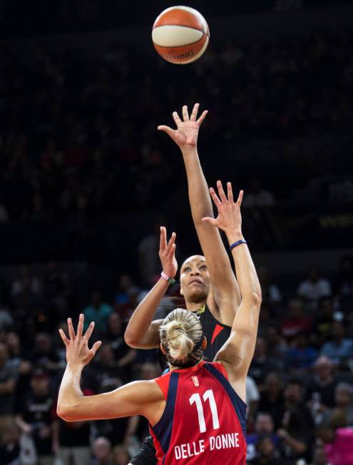 Las Vegas Aces center A'ja Wilson (22) shoots over Washington Mystics forward Elena Delle Donne ...