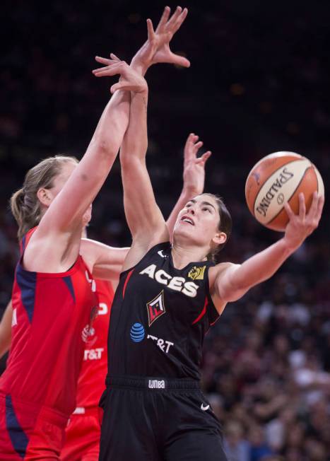 Las Vegas Aces guard Kelsey Plum (10) drives past Washington Mystics center Emma Meesseman (33) ...