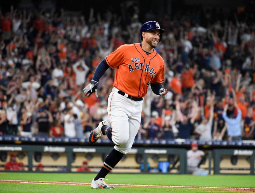 Houston Astros' George Springer rounds the bases after hitting a solo home run off Los Angeles ...