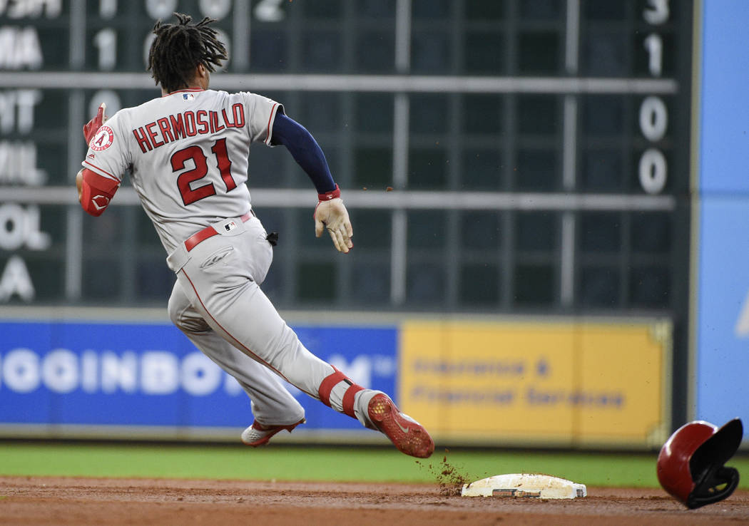 Los Angeles Angels' Michael Hermosillo runs to third after hitting a triple during the second i ...