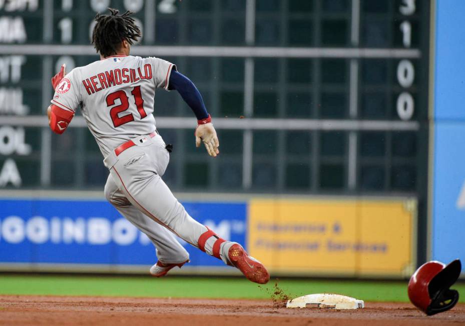 Los Angeles Angels' Michael Hermosillo runs to third after hitting a triple during the second i ...