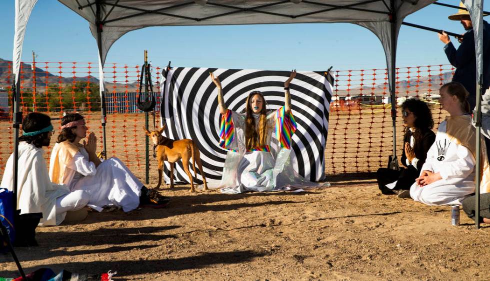 UNICULT leader Unicole, center, leads a morning prayer service for her members and festivalgoer ...