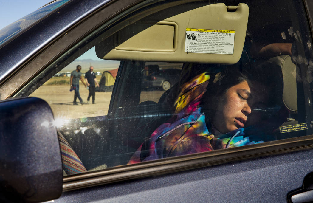 A festivalgoer sleeps in her car in the near-empty camping area during the Alienstock festival ...